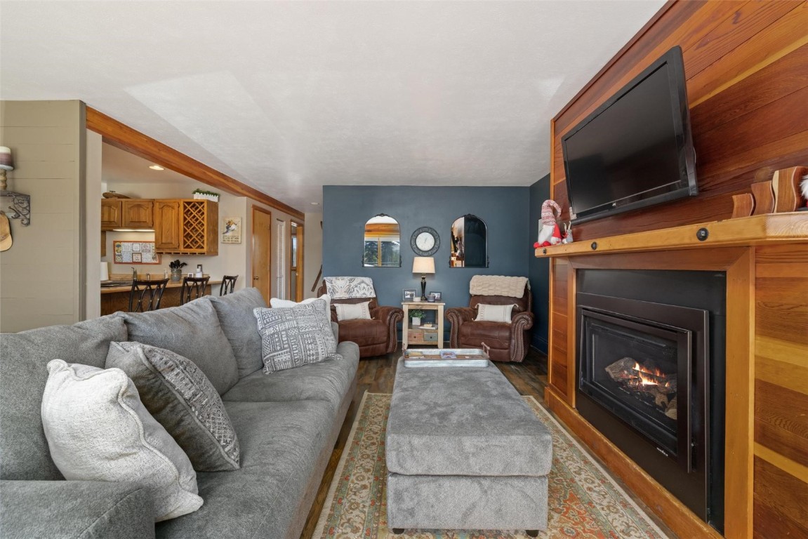 91200 Ryan Gulch Road, Unit 91204 Wildernest, CO 80498 - Photo 14 of 21 a living room with furniture a flat screen tv and a fireplace