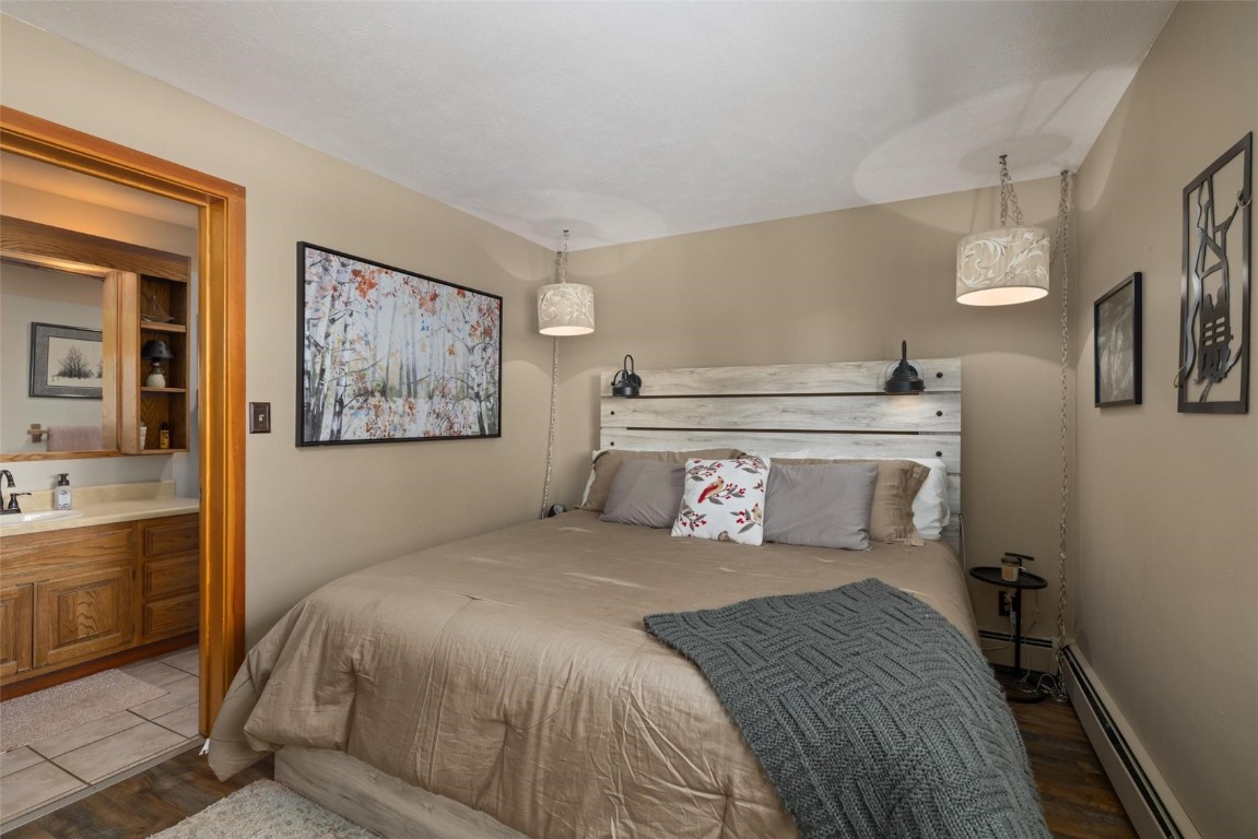 91200 Ryan Gulch Road, Unit 91204 Wildernest, CO 80498 - Photo 18 of 21 a bedroom with a large bed and a desk