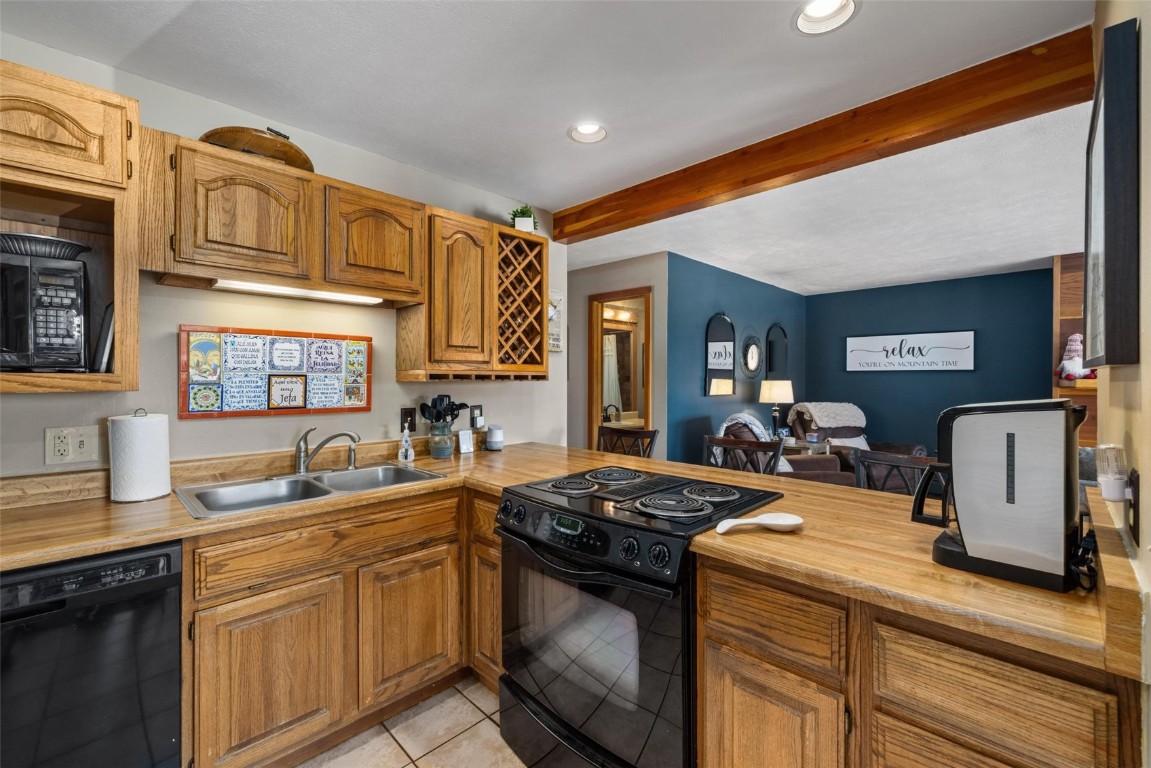 91200 Ryan Gulch Road, Unit 91204 Wildernest, CO 80498 - Photo 3 of 21 a kitchen with stainless steel appliances granite countertop a sink stove and cabinets