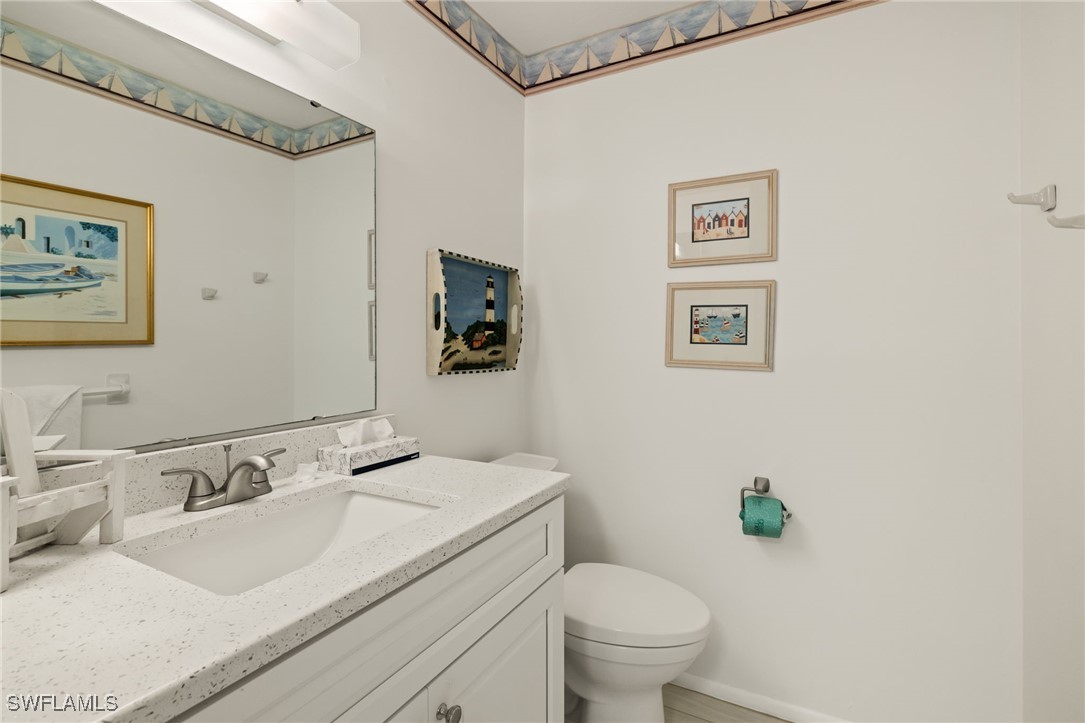 5117 Sea Bell Road, Unit C207 Sanibel, FL 33957 - Photo 15 of 43 a bathroom with a granite countertop sink mirror vanity and toilet