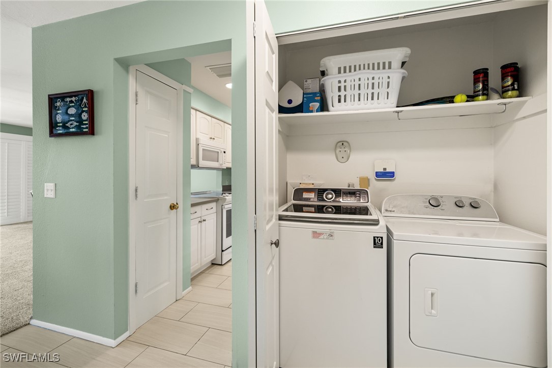 5117 Sea Bell Road, Unit C207 Sanibel, FL 33957 - Photo 16 of 43 a view of storage and utility room with washer and dryer