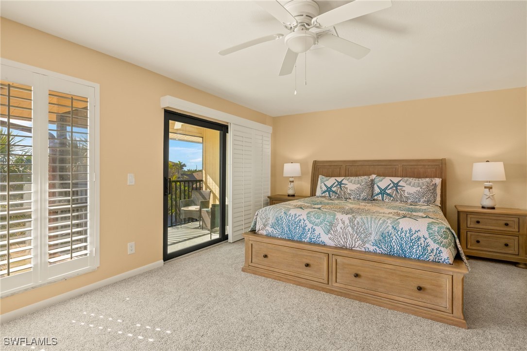 5117 Sea Bell Road, Unit C207 Sanibel, FL 33957 - Photo 17 of 43 a spacious bedroom with a large bed and a chandelier fan