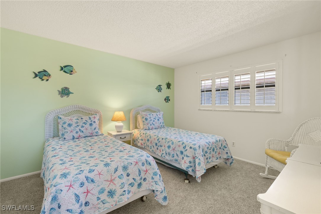 5117 Sea Bell Road, Unit C207 Sanibel, FL 33957 - Photo 22 of 43 a bedroom with two beds and a window