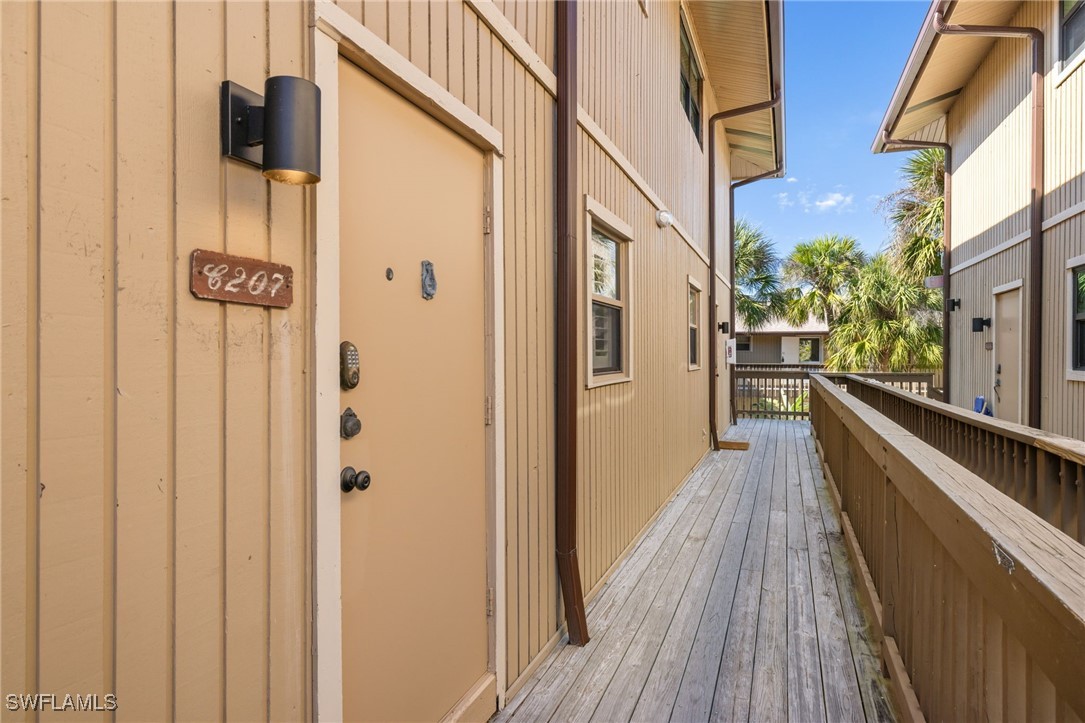 5117 Sea Bell Road, Unit C207 Sanibel, FL 33957 - Photo 24 of 43 a view of a balcony with wooden floor and fence
