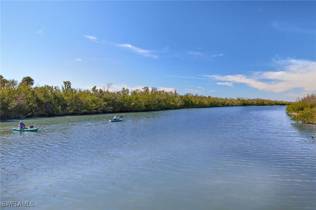5117 Sea Bell Road, Unit C207 Sanibel, FL 33957 - Photo 36 of 43 a view of a lake with houses in the back