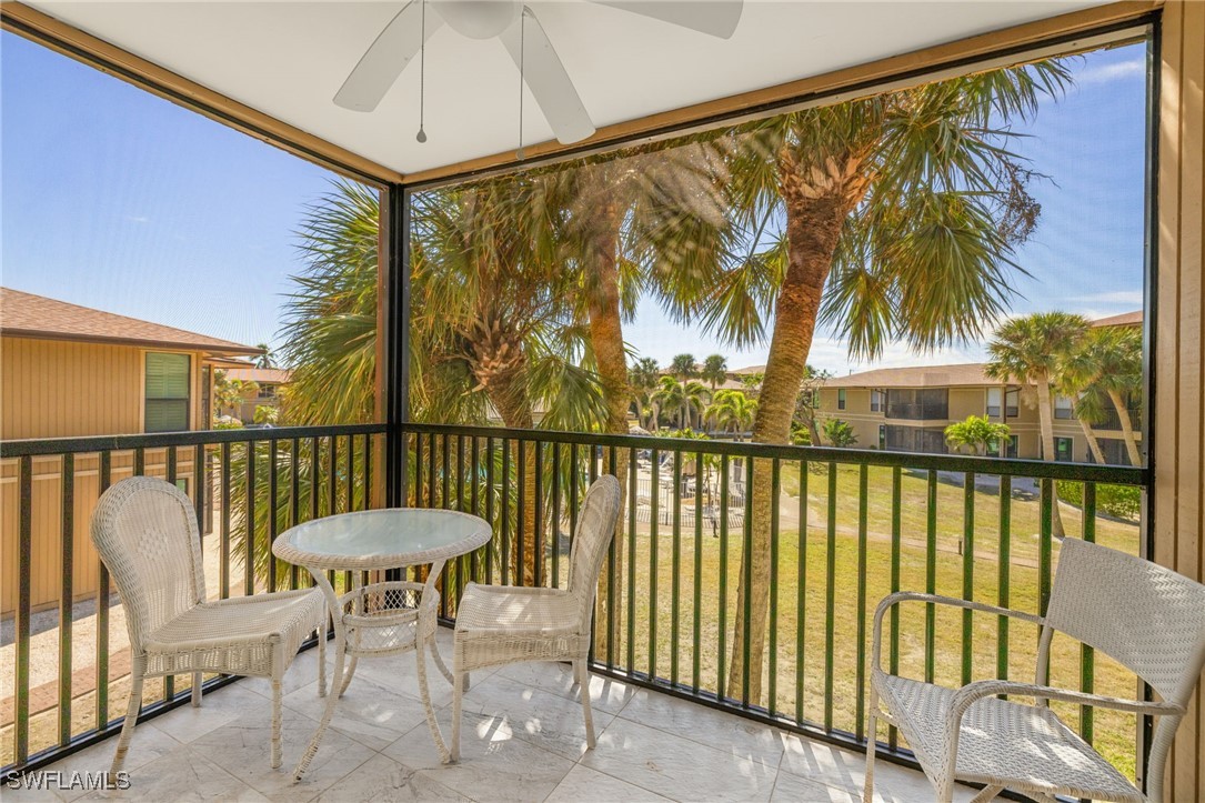 5117 Sea Bell Road, Unit C207 Sanibel, FL 33957 - Photo 5 of 43 a view of a balcony with a table and chairs