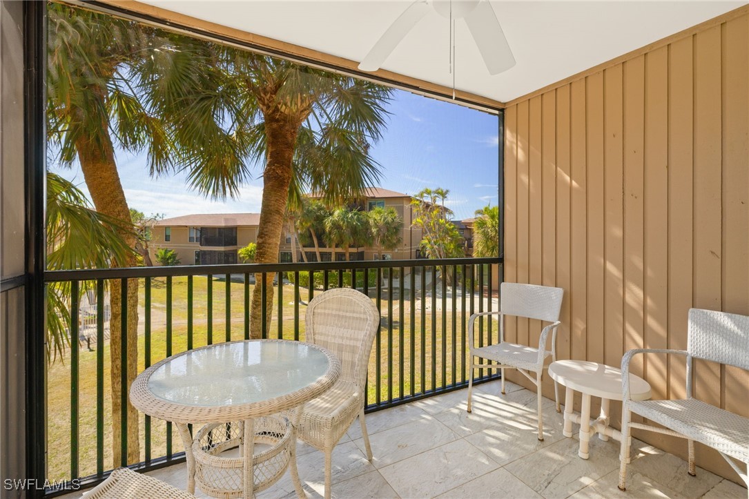 5117 Sea Bell Road, Unit C207 Sanibel, FL 33957 - Photo 6 of 43 a view of a balcony with furniture and floor to ceiling window