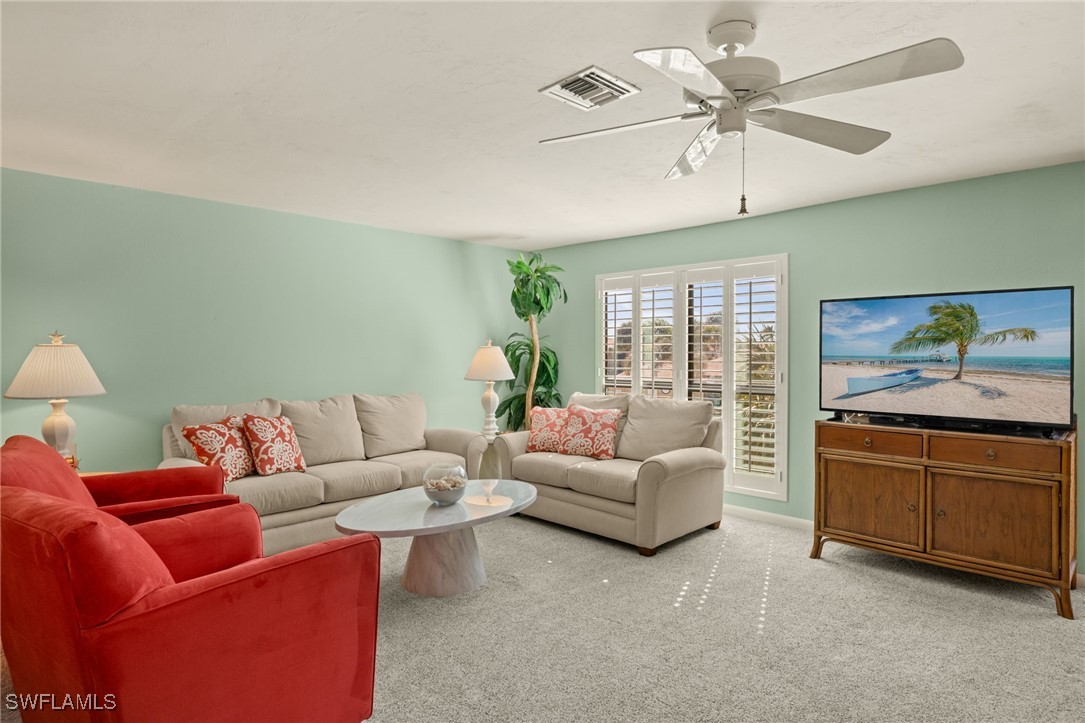 5117 Sea Bell Road, Unit C207 Sanibel, FL 33957 - Photo 7 of 43 a living room with furniture and a large window
