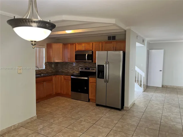 a white toilet and tub sitting next to a bathroom sink