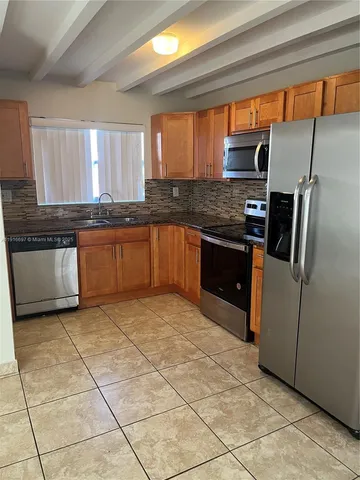 an empty room with a empty space and windows