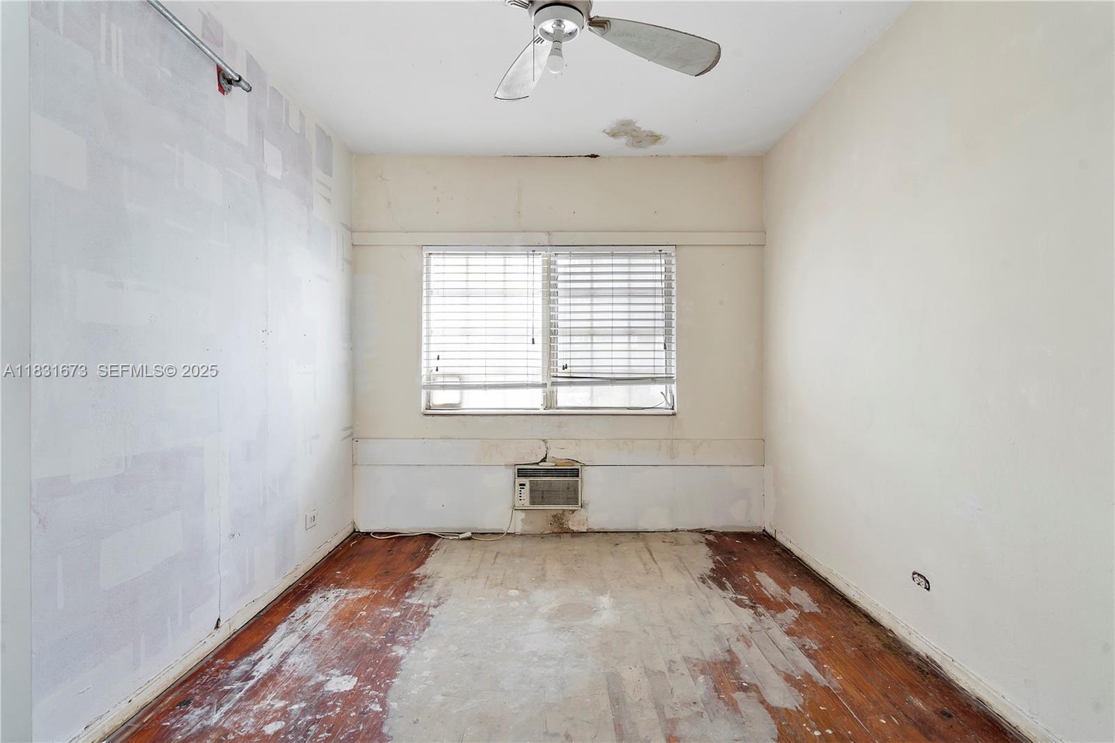 836 10th Street, Unit 6 Miami Beach, FL 33139 - Photo 11 of 12 wooden floor in an empty room with a window