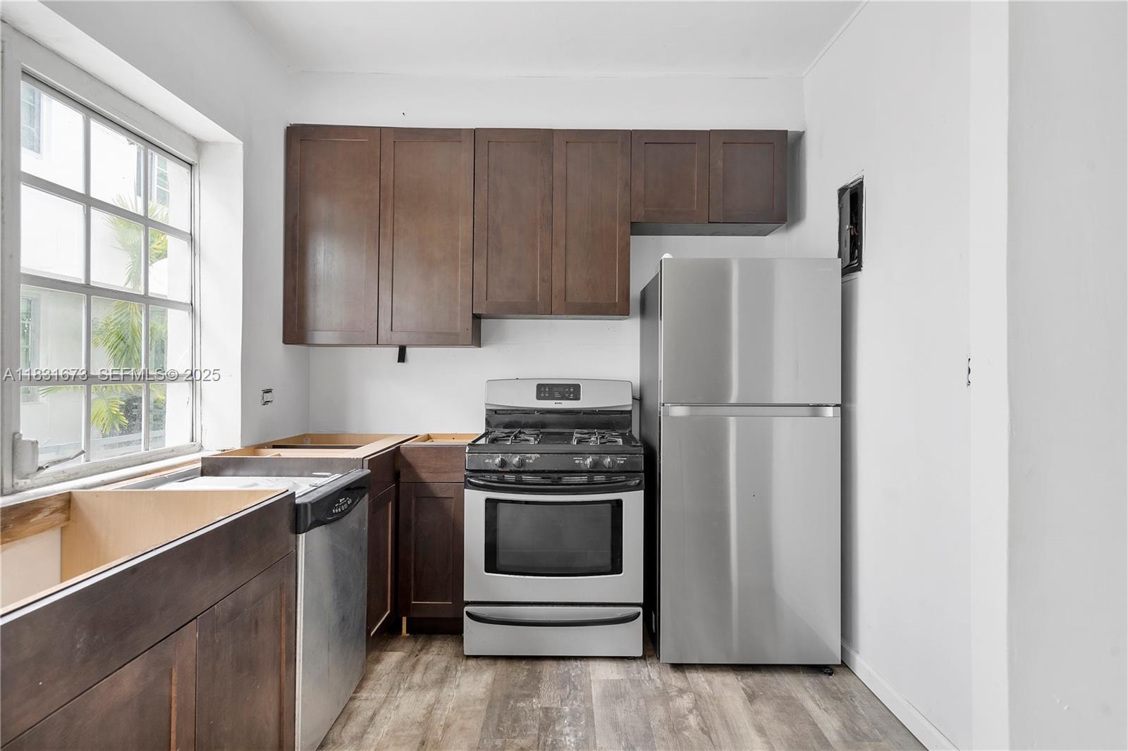 836 10th Street, Unit 6 Miami Beach, FL 33139 - Photo 4 of 12 a kitchen with a stove a refrigerator and a sink