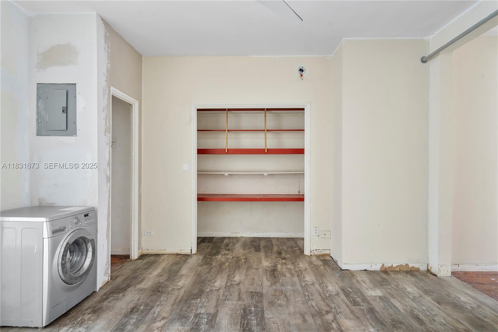 836 10th Street, Unit 6 Miami Beach, FL 33139 - Photo 9 of 12 a view of walk in closet with clothes and shoes