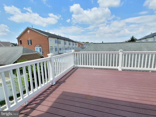 a terrace view with wooden floor and fence