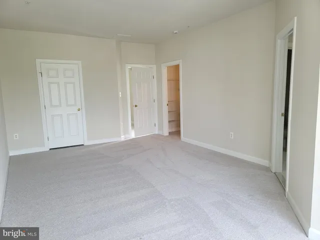 a view of an empty room and closet area