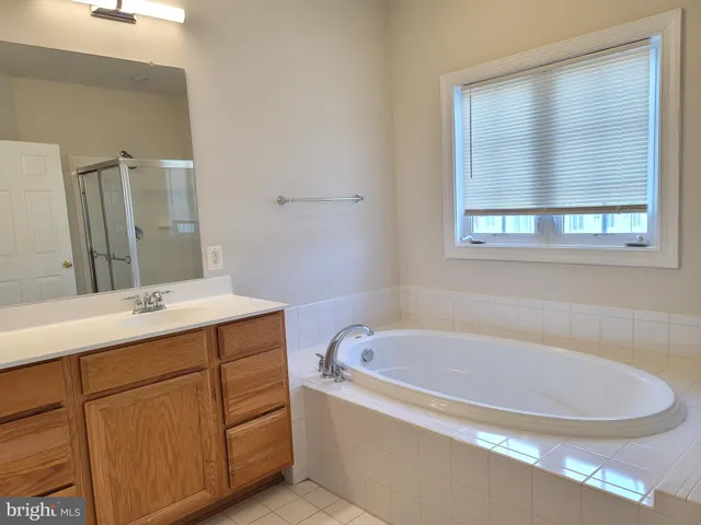a white bath tub sitting next to a white sink