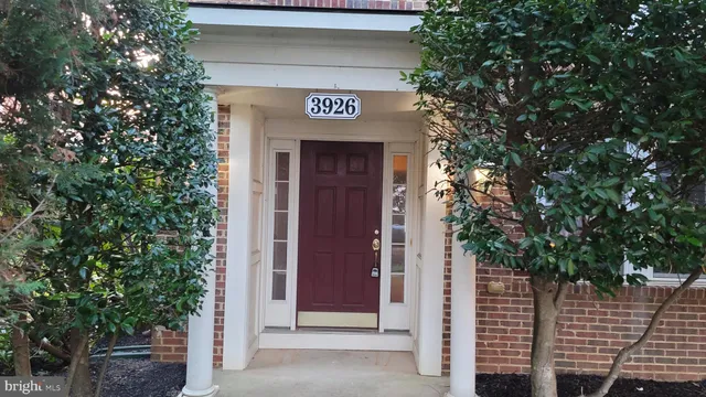 a view of a wooden door and brick wall