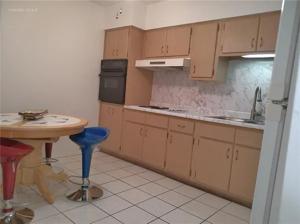 a kitchen with a sink cabinets and appliances