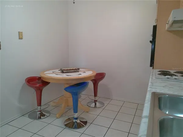 a spacious bedroom with a bed and a table chair