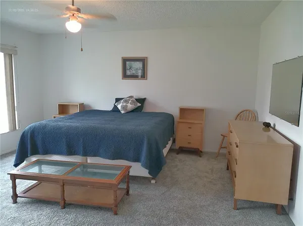 a living room with a bed furniture and a window
