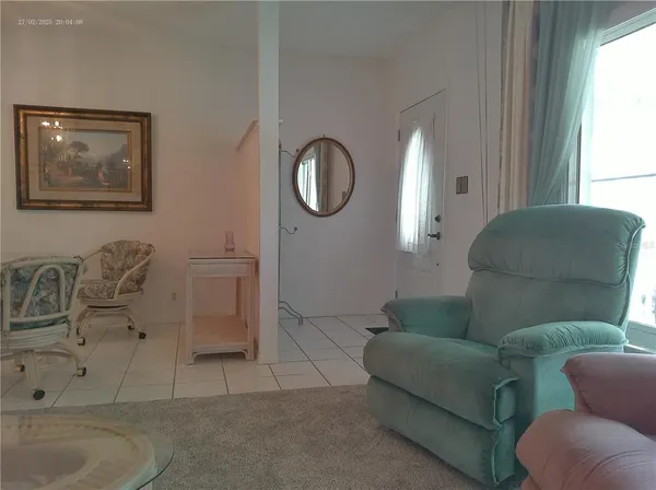 a living room with furniture a couch and a window