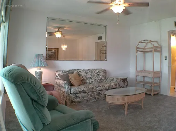 a living room with furniture a lamp and a chandelier