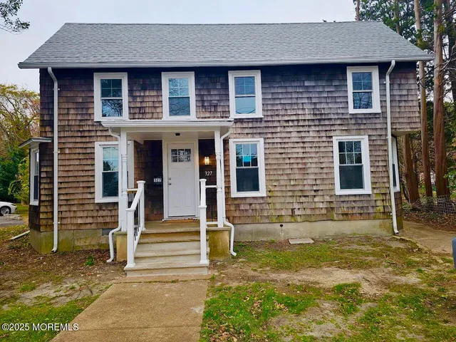 a front view of a house with stairs
