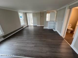 327 Mantoloking Road Brick, NJ 08723 - Photo 8 of 12 a view of an empty room with wooden floor and a window