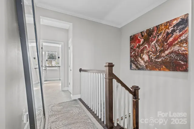 a view of a hallway with wooden floor and entryway
