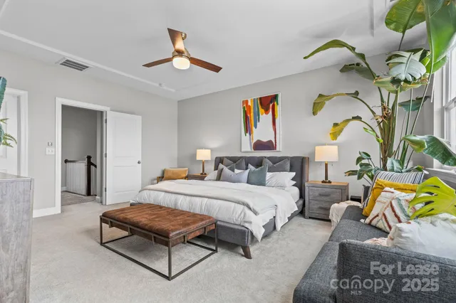 a bedroom with a bed couch and window