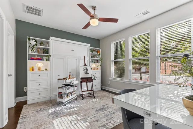 a living room with furniture a large window and a chandelier
