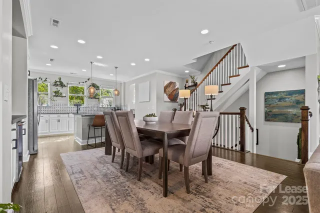 a dining room with furniture and wooden floor