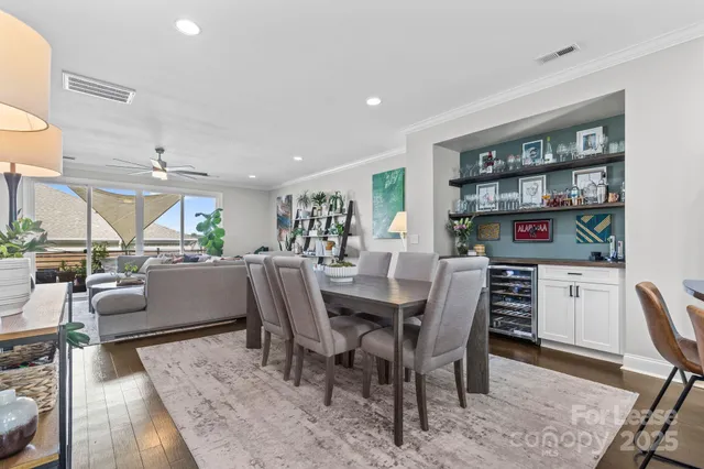 a dining room with furniture and a book shelf