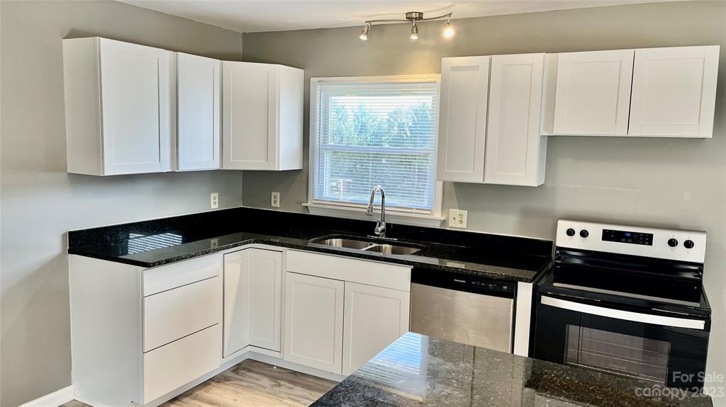 6440 Miller Road Kannapolis, NC 28081 - Photo 6 of 15 a kitchen with granite countertop a sink a stove and cabinets