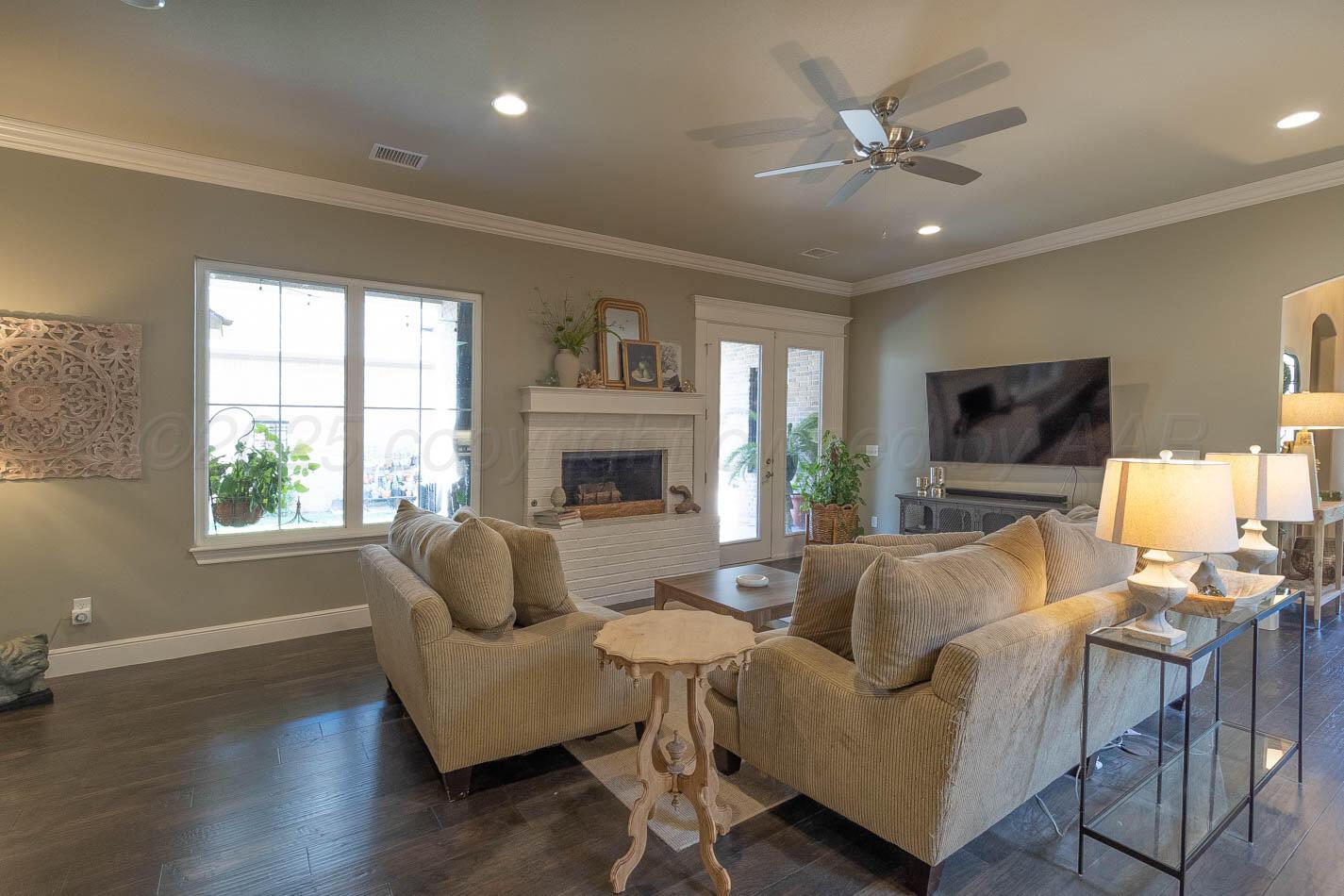 6809 Baccus Amarillo, TX 79124 - Photo 11 of 20 a living room with furniture fireplace and a flat screen tv