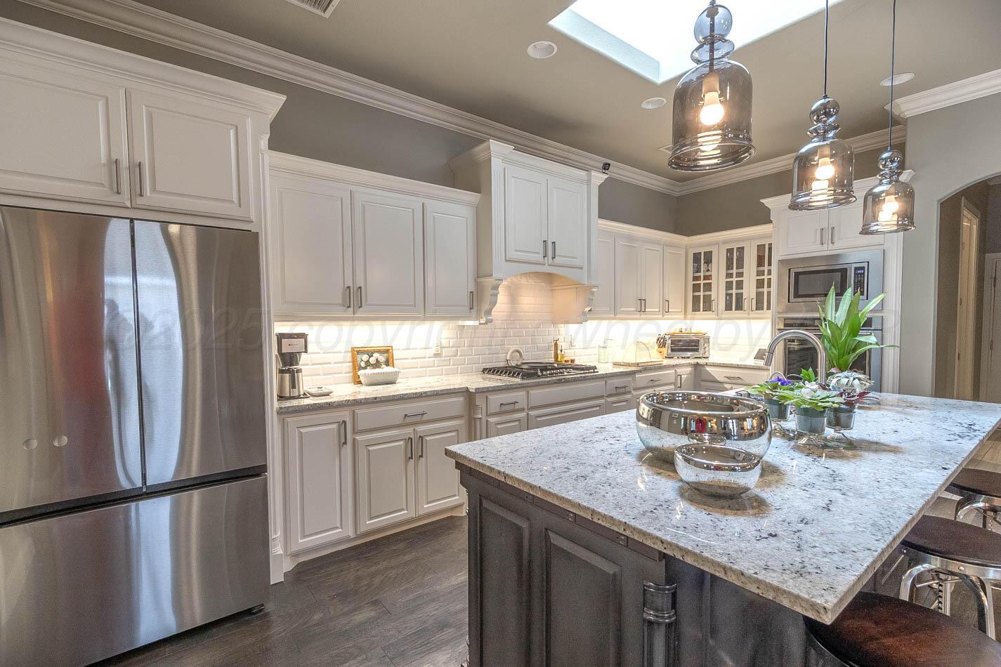 6809 Baccus Amarillo, TX 79124 - Photo 14 of 20 a kitchen with stainless steel appliances granite countertop a sink refrigerator and cabinets