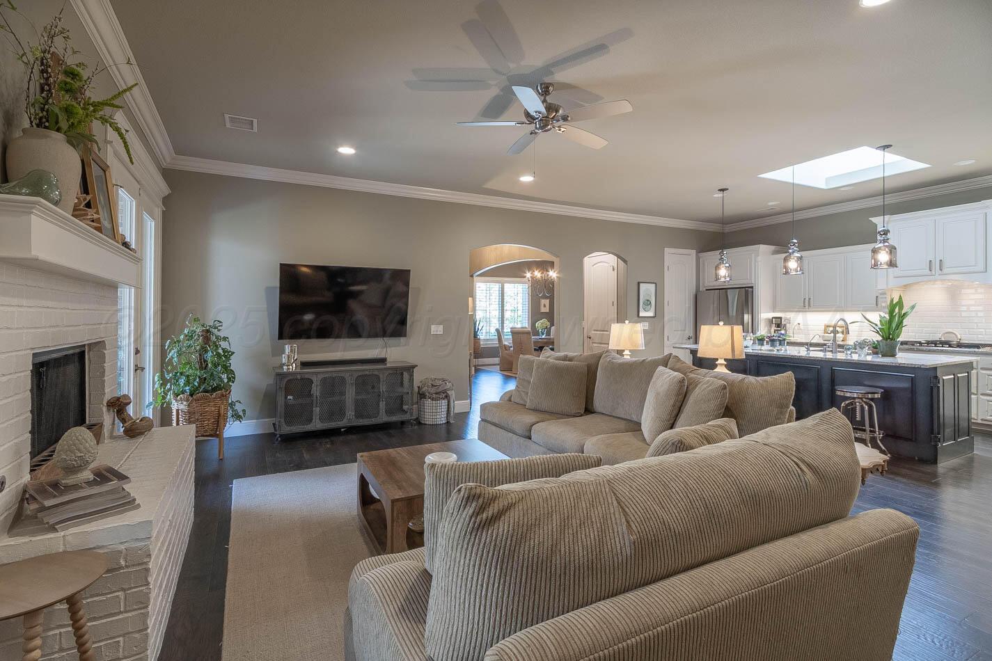 6809 Baccus Amarillo, TX 79124 - Photo 2 of 20 a living room with furniture a fireplace and a flat screen tv