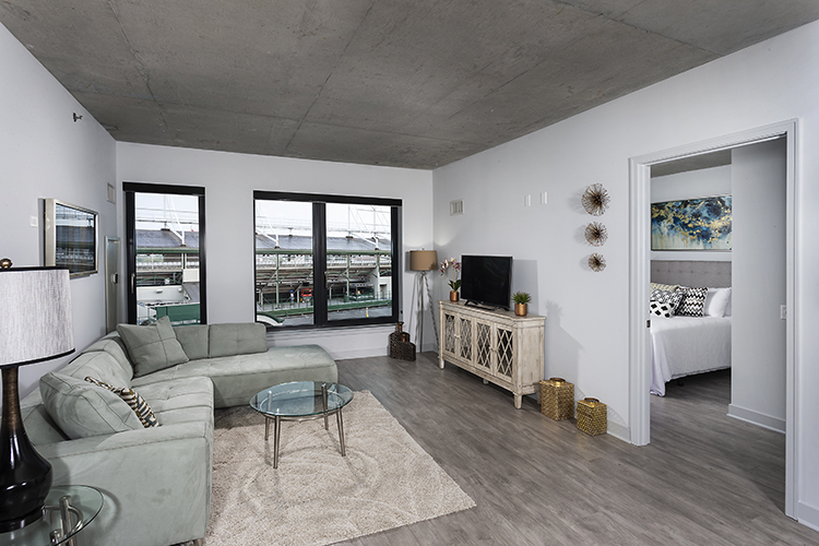 1025 West Addison Street, Unit 701 Chicago, IL 60613 - Photo 5 of 17 a living room with furniture flat screen tv and wooden floor