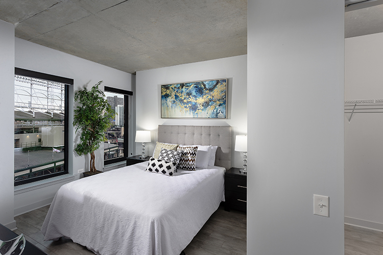 1025 West Addison Street, Unit 701 Chicago, IL 60613 - Photo 6 of 17 a bedroom with a bed and a large window