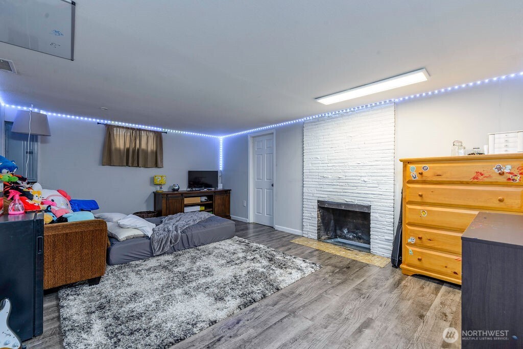 814 117th Street South Tacoma, WA 98444 - Photo 16 of 22 a bedroom with furniture and a fireplace