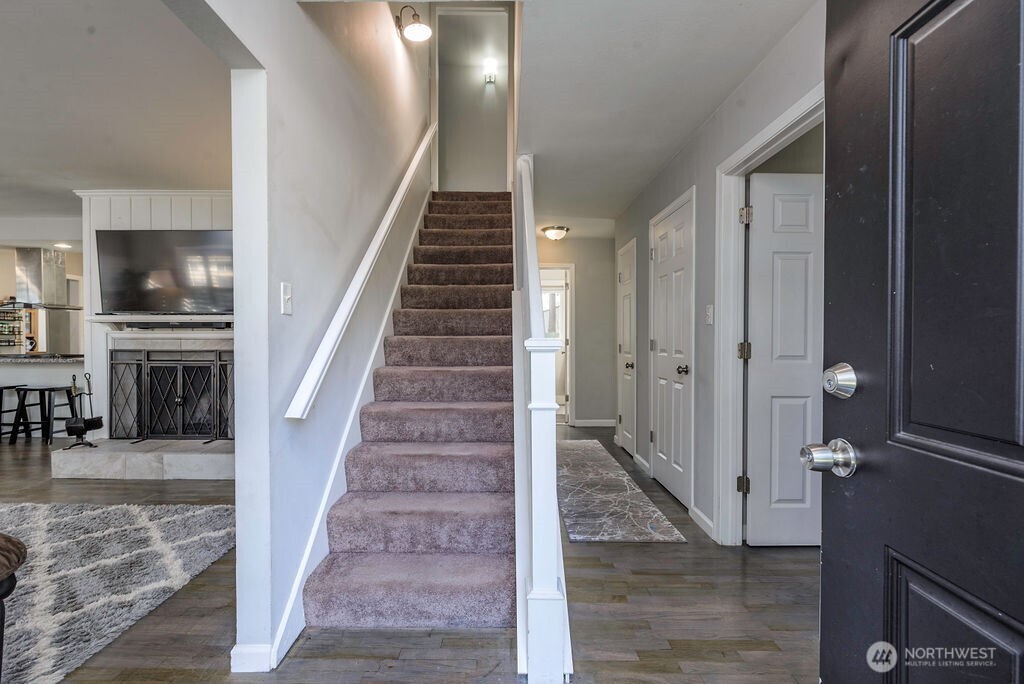 814 117th Street South Tacoma, WA 98444 - Photo 4 of 22 a view of a hallway with dining room and stairs
