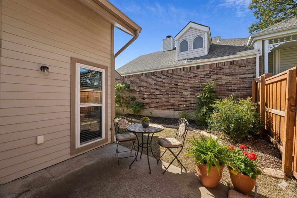 18111 Whispering Gables Lane Dallas, TX 75287 - Photo 14 of 15 a balcony with table and chairs and potted plants