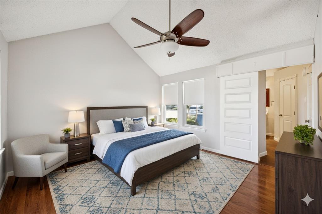 18111 Whispering Gables Lane Dallas, TX 75287 - Photo 8 of 15 a spacious bedroom with a bed and a couch