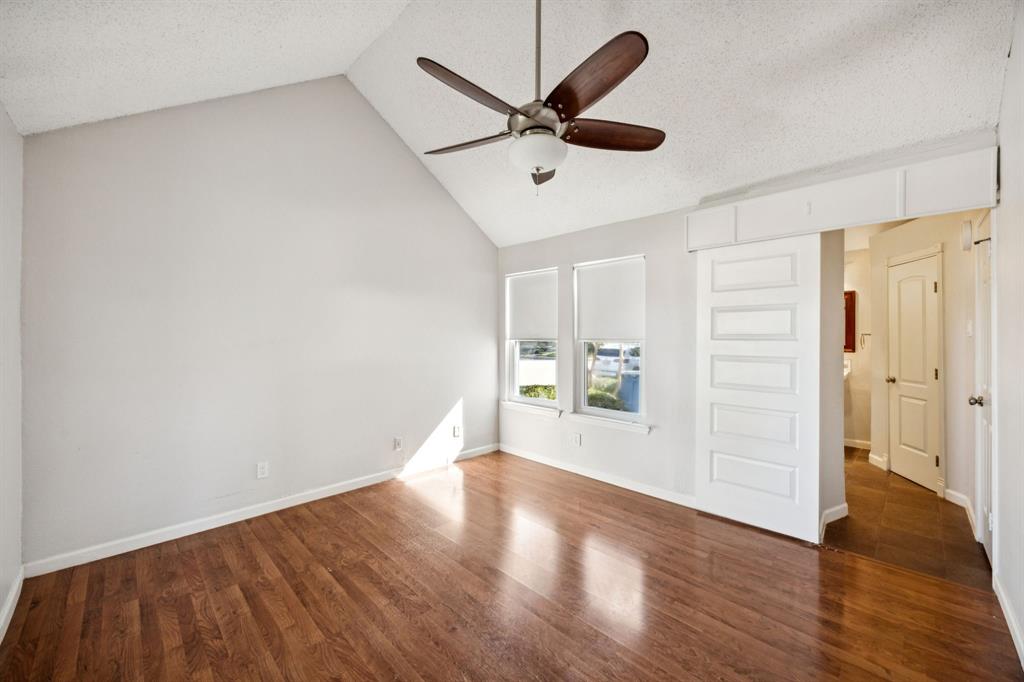 18111 Whispering Gables Lane Dallas, TX 75287 - Photo 9 of 15 a view of a livingroom with wooden floor and a ceiling fan