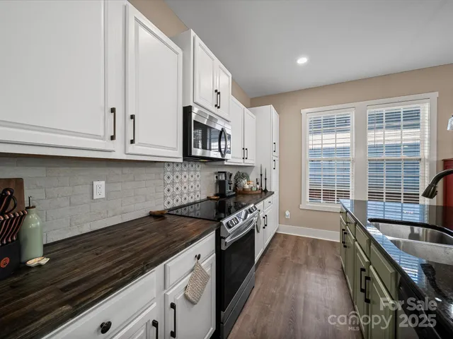 a bathroom with a shower a toilet and a glass door