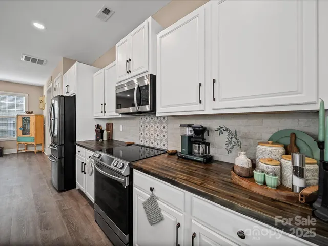 a view of a hallway with wooden floor and stairs