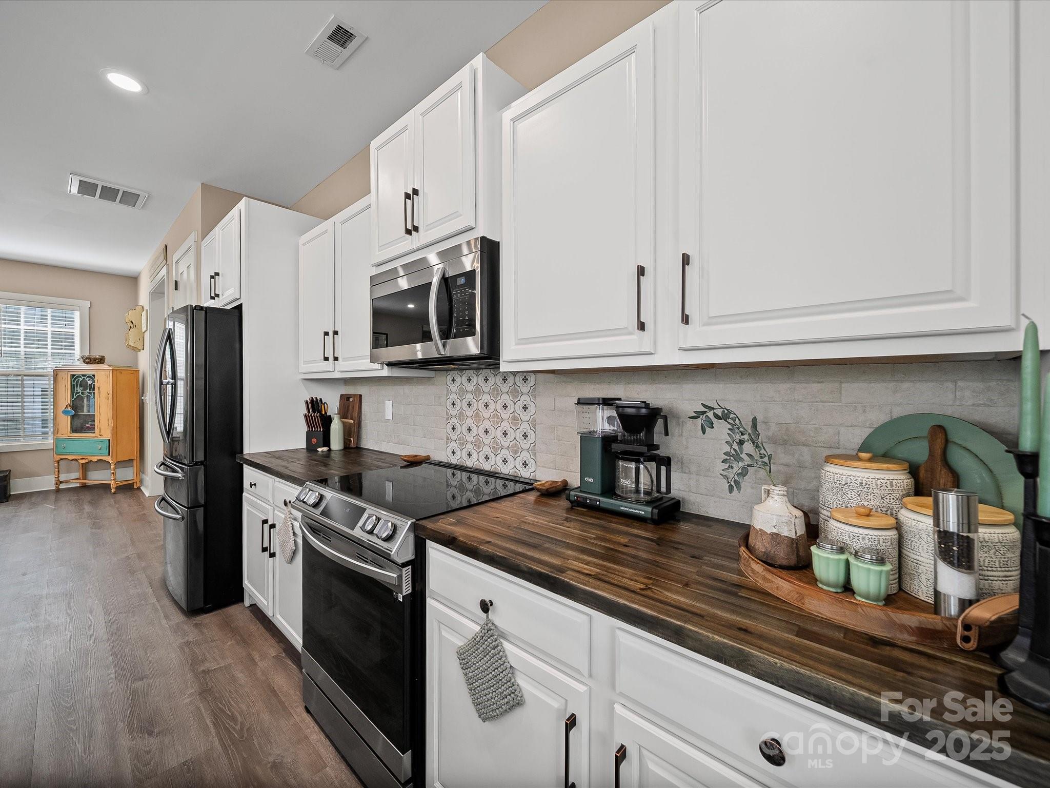 28117 Egrets Court Lancaster, SC 29720 - Photo 13 of 46 a kitchen with stainless steel appliances granite countertop a stove a sink and a white cabinets