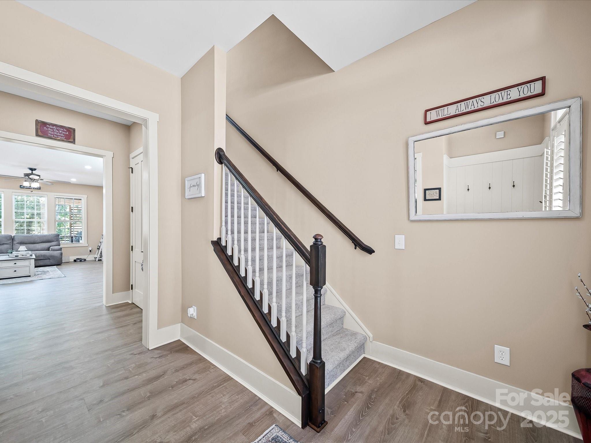 28117 Egrets Court Lancaster, SC 29720 - Photo 18 of 46 a view of a hallway with wooden floor and stairs