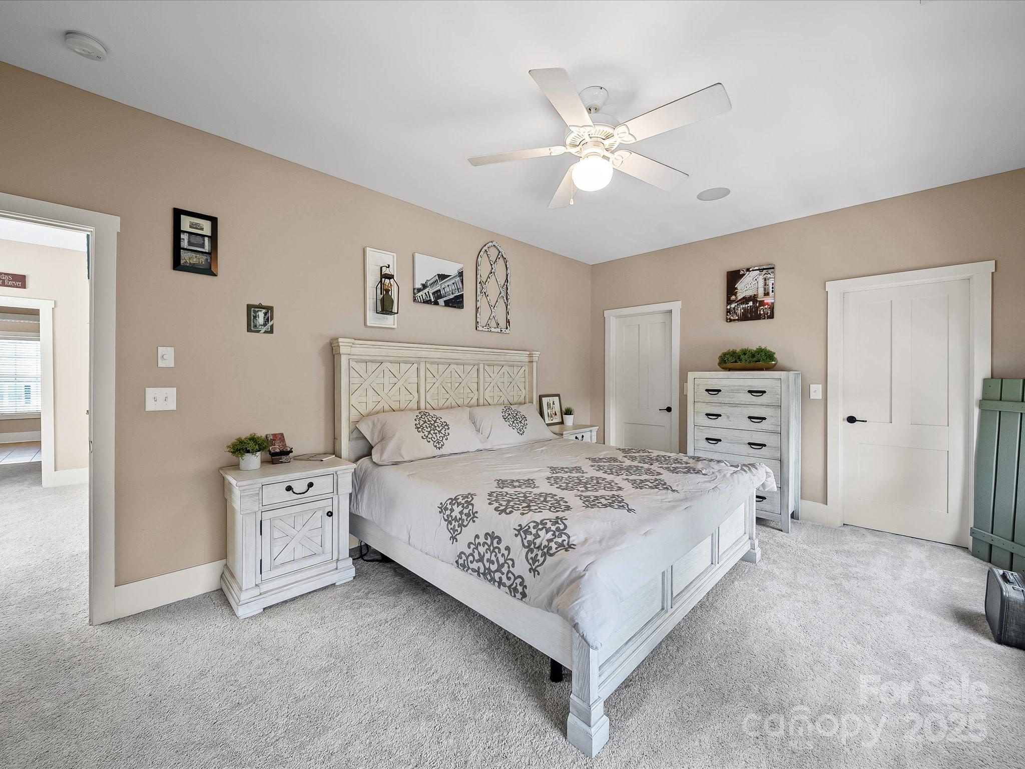 28117 Egrets Court Lancaster, SC 29720 - Photo 20 of 46 a bedroom with a bed and a chandelier