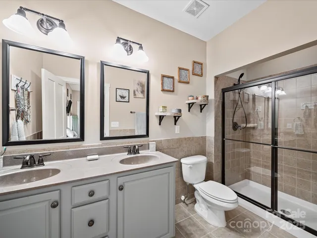 an aerial view of a house with a garden and lake view